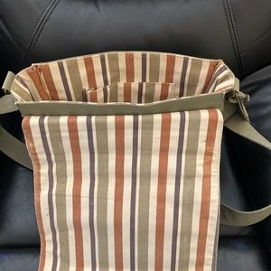 Jeanne Lottie light khaki computer-book bag with stripped fabric interior.